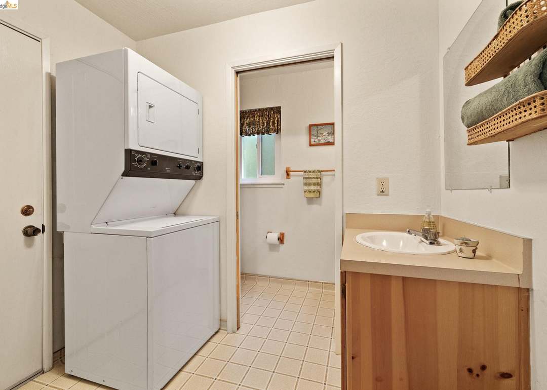 Laundry room with stacked washer and dryer