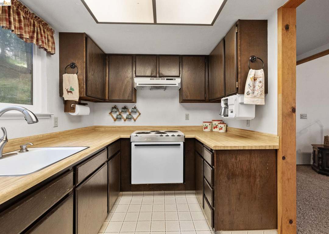 Kitchen with dark wood cabinets and skylight